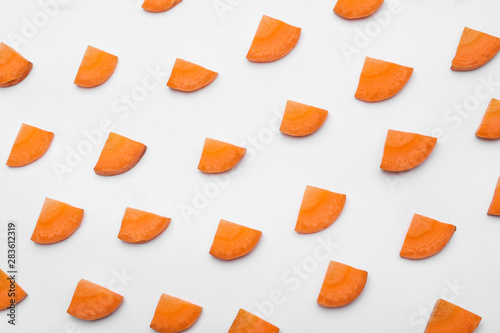 Slices of fresh raw carrots isolated on white, top view
