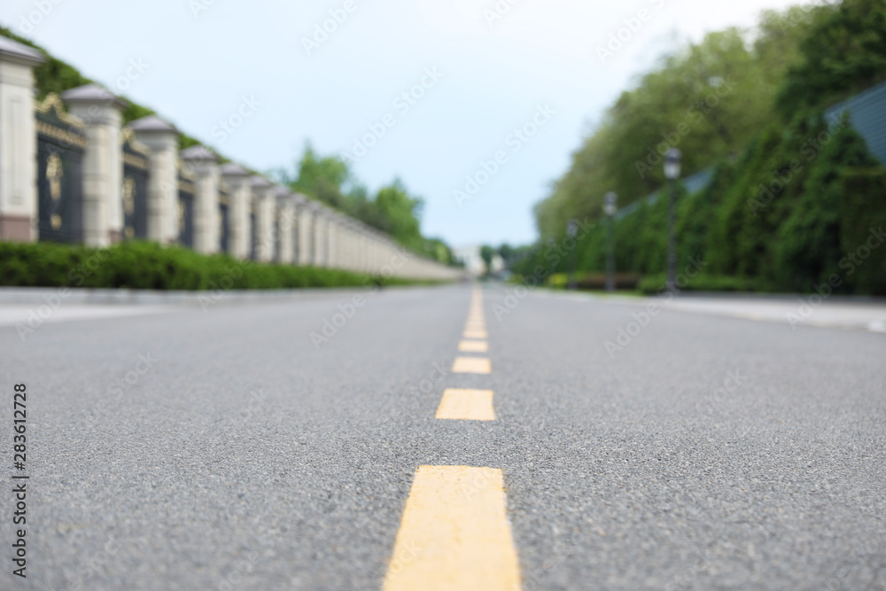 Yellow dividing lines on asphalt road in city