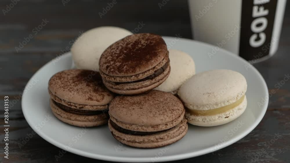 Macaroons and coffee in white paper cup Macaroons and coffee in white paper cup