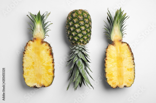 Tasty ripe pineapples on white background, top view