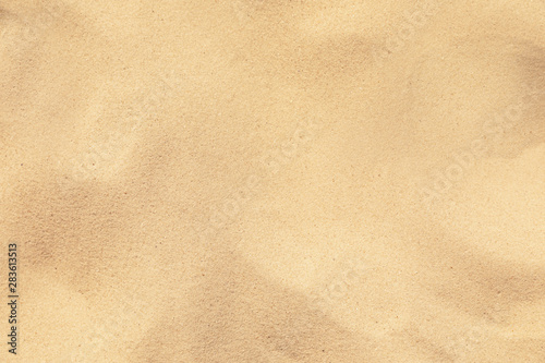 Golden beach sand on sunny day as background