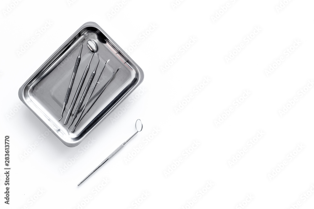 Dentist work desk with tools for teeth on white background top view mock up Dentist work desk with tools for teeth on white background top view mock up