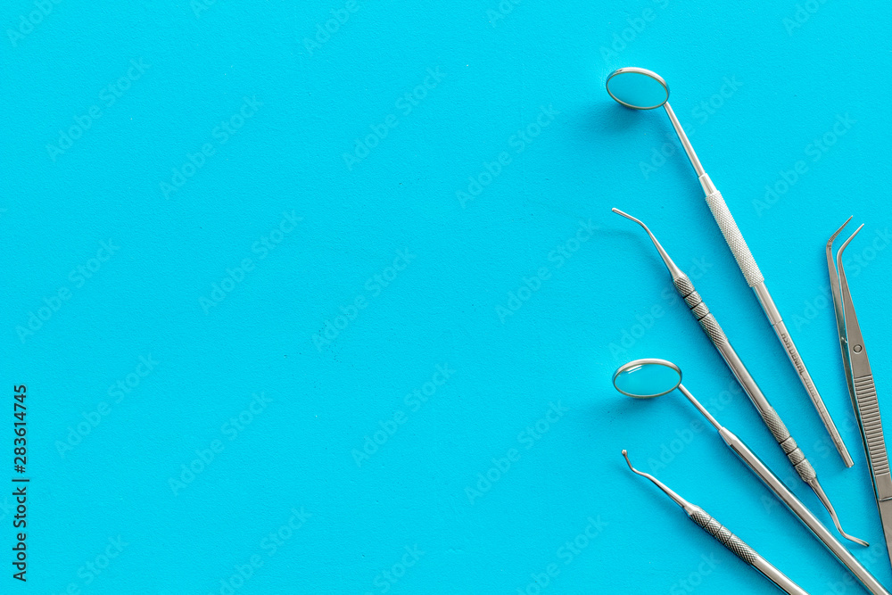stomatologist instruments on blue doctor's office desk background top view mock-up stomatologist instruments on blue doctor's office desk background top view mock-up