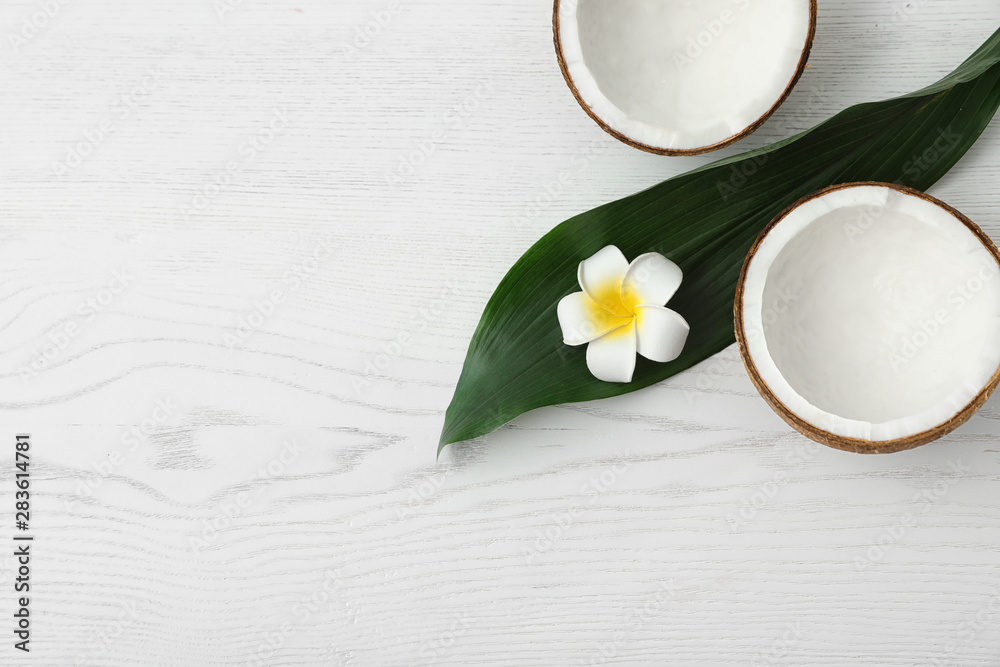 Flat lay composition with halves of coconut on white wooden background. Space for text Flat lay composition with halves of coconut on white wooden background. Space for text