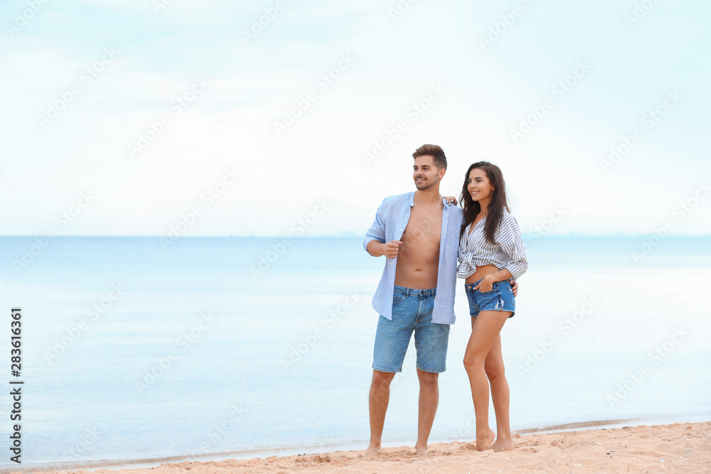 Happy young couple spending time together on beach