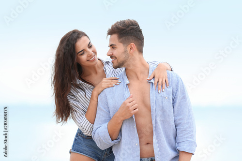 Happy young couple spending time together on beach