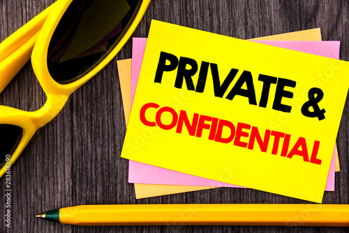 Conceptual hand text showing Private And Confidential. Business photo showcasing Security Secret Sensitive Classified Information written Stiky Note Paper with Pen the wood background. photo