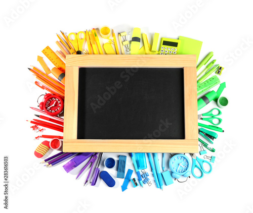 Composition with different school stationery and blank small chalkboard on white background, top view