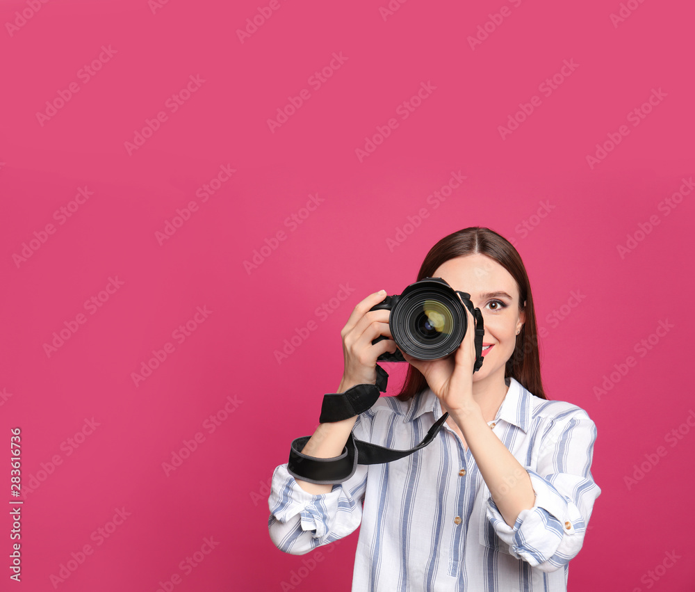 Professional photographer taking picture on pink background. Space for text Professional photographer taking picture on pink background. Space for text