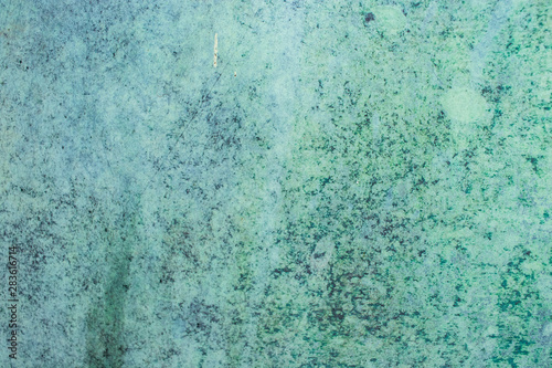 Green grunge painted wall surface worn weathered dirty old rough vintage background surface texture