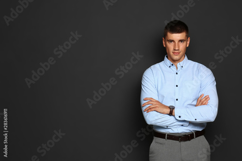 Portrait of handsome young man on dark background. Space for text