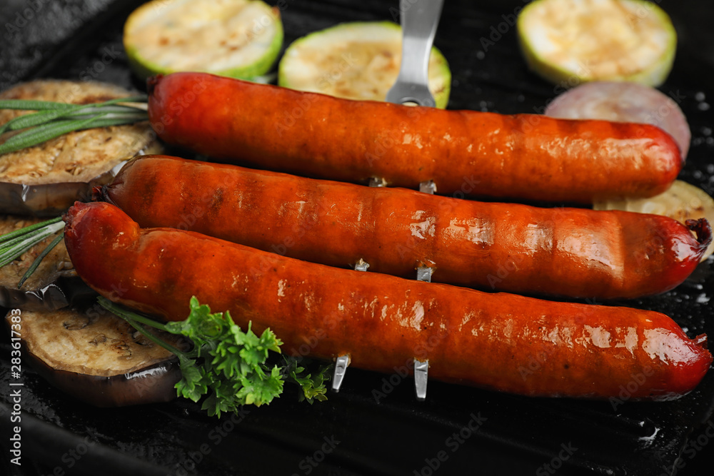 Delicious grilled sausages and vegetables in grill pan, closeup Delicious grilled sausages and vegetables in grill pan, closeup