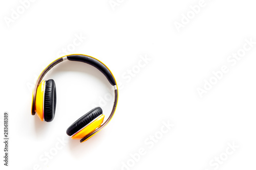 Wireless headphones as music gadgets on white background top view mock-up