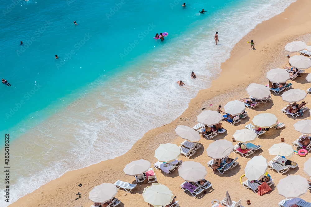 Sea waves and beach with sun umbrellas, aeral view, Kaputash beach Sea waves and beach with sun umbrellas, aeral view, Kaputash beach