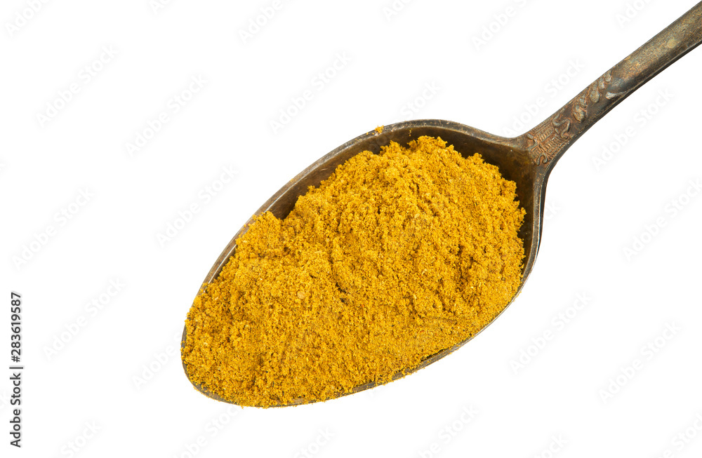 Turmeric powder in an old spoon on an isolated white background. View from above. Spices in a spoon on isolate. Turmeric powder in an old spoon on an isolated white background. View from above. Spices in a spoon on isolate.