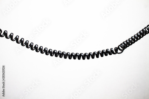black vintage spring cable (wire) on white background hotizontly 