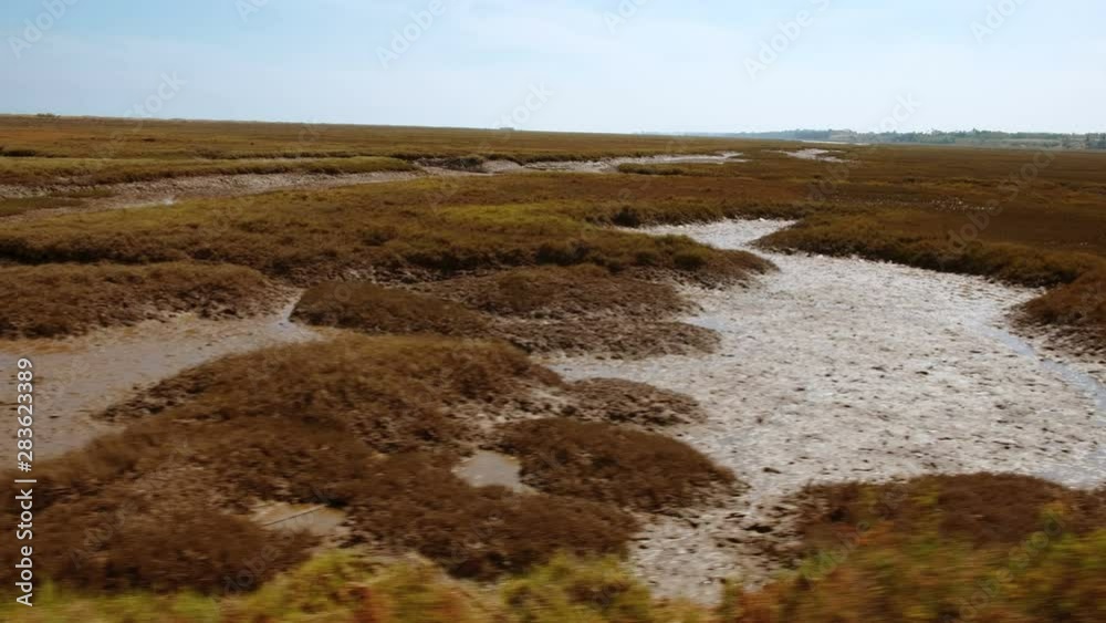 Tracking shot of the stunning Ria Formosa lagoon, in The Algarve, Portugal a system of barrier islands connected with the sea Tracking shot of the stunning Ria Formosa lagoon, in The Algarve, Portugal a system of barrier islands connected with the sea