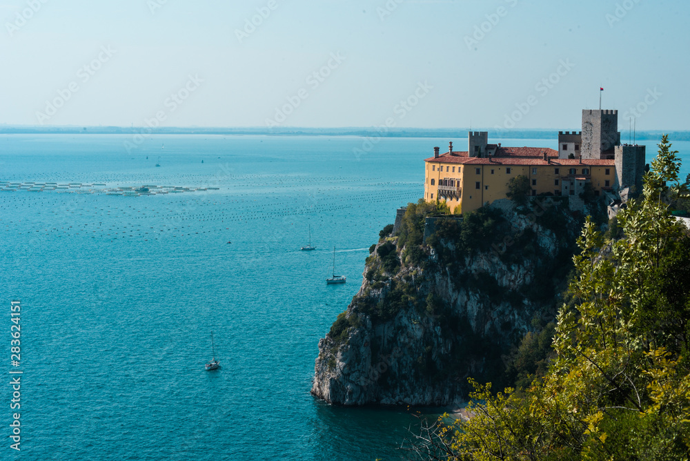 Side wide angle view of Duino's Castle overlookingthe sea in Trieste, Friuli Venezia Giulia Italy, 400 years old.