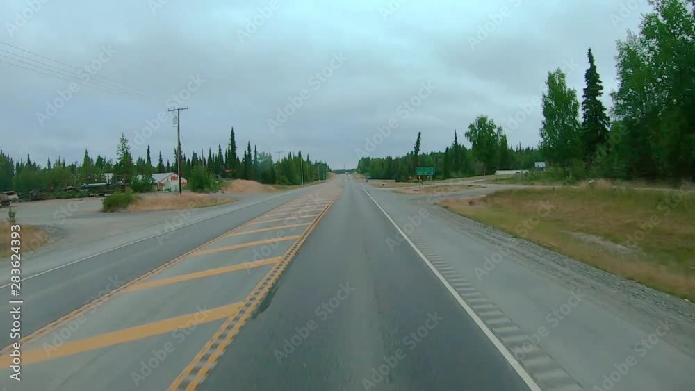 POV 2X through the front windshield while driving through the town of Sterling, Alaska; from this section of the Sterling the Kenai Mountains are visible POV 2X through the front windshield while driving through the town of Sterling, Alaska; from this section of the Sterling the Kenai Mountains are visible