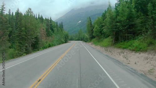 POV X2 through front windshield while driving on the Sterling Highway in Alaska; visible are smoke from local wildfire, Chugach National Forest and Kenai Mountains photo