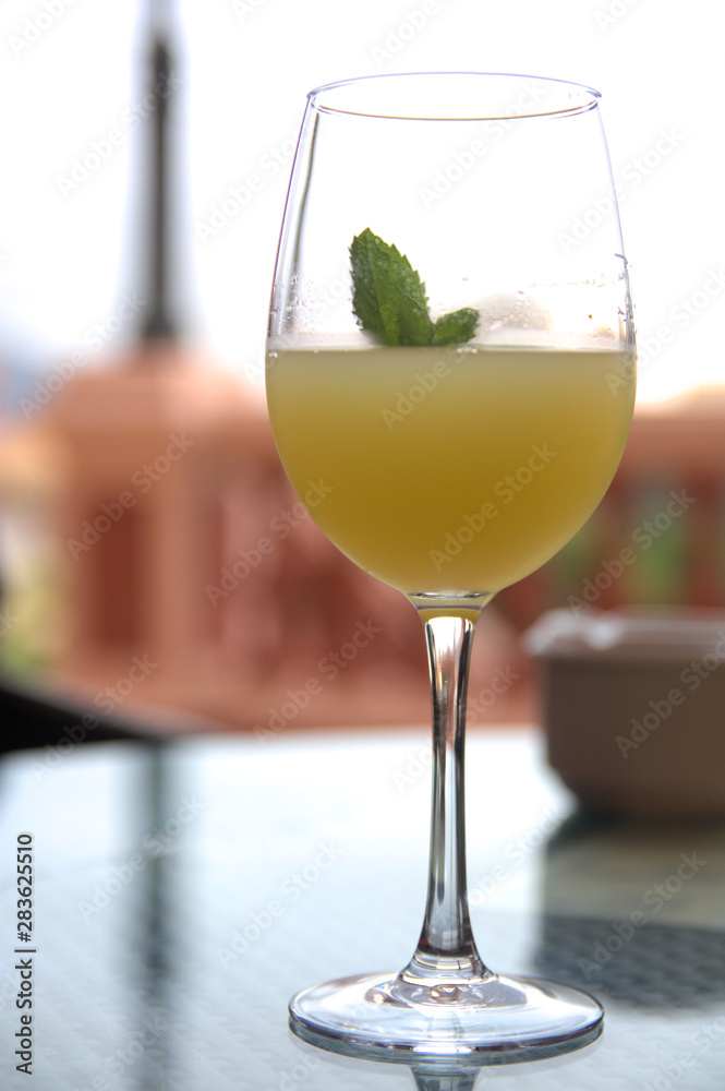 Glass of refreshing drink on a bar table with unfocused background Glass of refreshing drink on a bar table with unfocused background