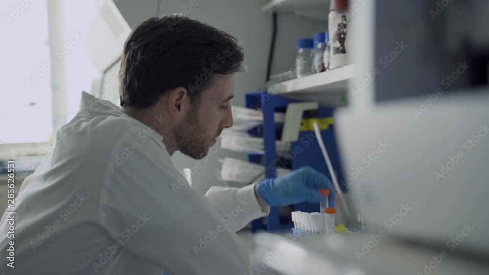 Scientist going over test samples and then finds one and gets excited and happy Scientist going over test samples and then finds one and gets excited and happy
