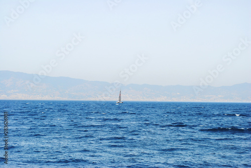 Seascape. Sailing vessel. View of Sicily, Italy.