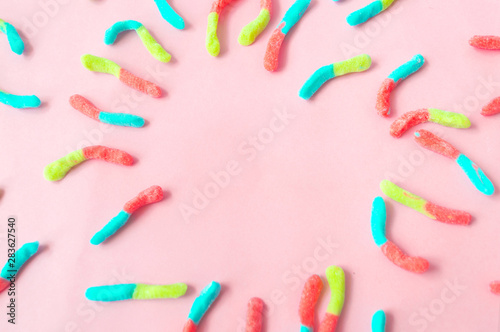 gomitas de diferentes  colores  sobre un fondo rosado photo