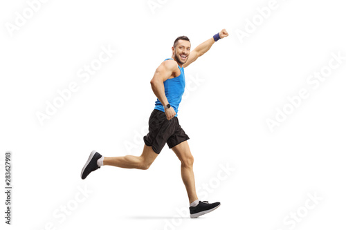 Young man running and gesturing with hand