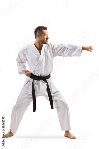 Young man in kimono exercising karate