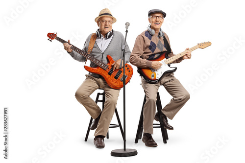 Two senior men sitting and playing electric guitars © Ljupco Smokovski
