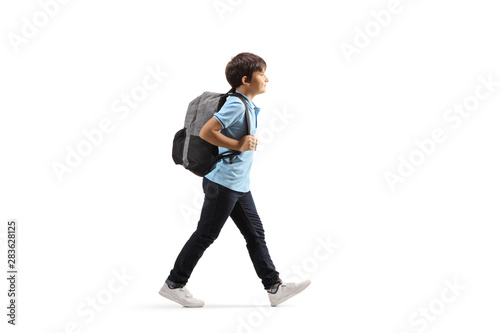Foto Schoolboy with a backpack walking