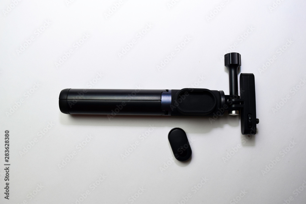 Close up Black selfie stick isolated on a white background Close up Black selfie stick isolated on a white background