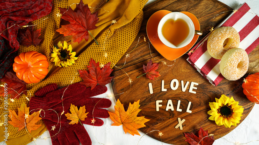 Autumn Fall theme flatlay overhead with cosy sweater, bagels, cups of herbal tea and scattered maple leaves. Autumn Fall theme flatlay overhead with cosy sweater, bagels, cups of herbal tea and scattered maple leaves.