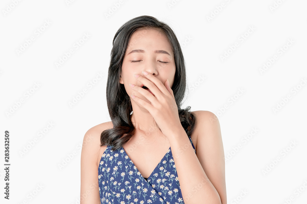 Asian woman yawning covering open mouth and showing a sleepy gesture. feeling being tired from hard work. on white background Asian woman yawning covering open mouth and showing a sleepy gesture. feeling being tired from hard work. on white background