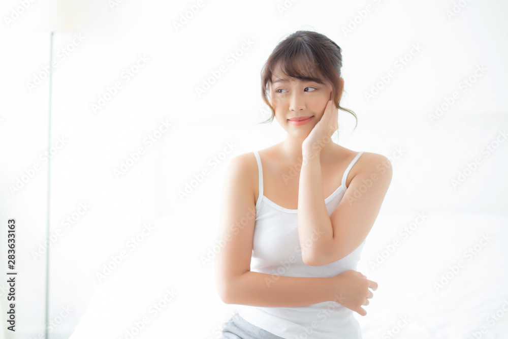 Portrait of beautiful young asian woman smile while wake up healthy and wellness with sunrise at morning in the bedroom, asia girl skin care with happy with fresh, lifestyle and relax concept. Portrait of beautiful young asian woman smile while wake up healthy and wellness with sunrise at morning in the bedroom, asia girl skin care with happy with fresh, lifestyle and relax concept.