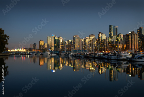 Coal Harbor Skyline Twilight Reflections. A calm Coal Harbor next to Stanley Park at twilight. Vancouver, British Columbia.