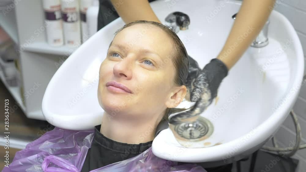 Process of washing your hair in a hairdresser. girl in a beauty salon. wash your hair, hair care, health. Process of washing your hair in a hairdresser. girl in a beauty salon. wash your hair, hair care, health.