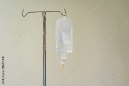 Close up saline solution drip for patient and infusion pump in hospital, with space and bright background at luxury VIP room