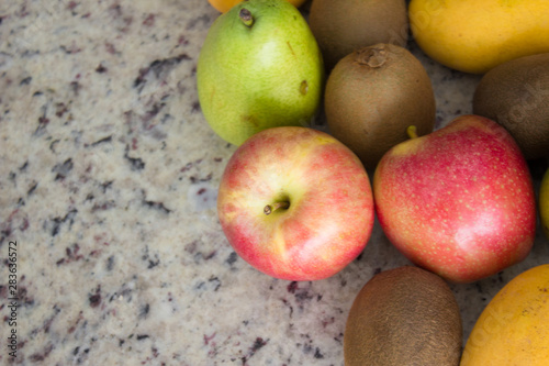 Fruits (kiwi, apple and pears) on a table