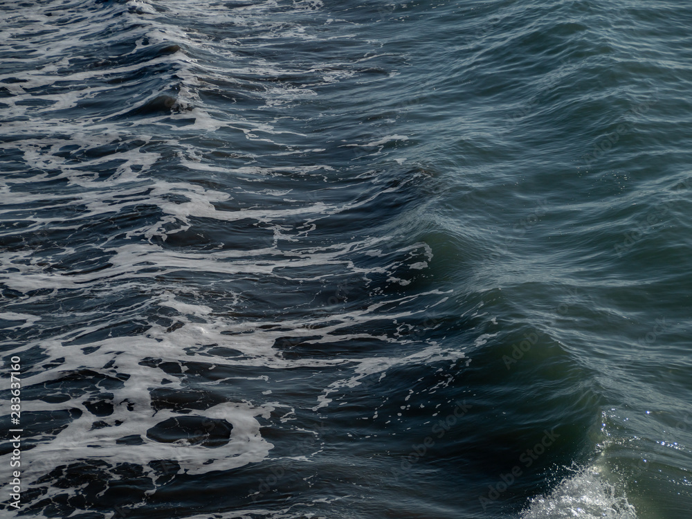 Sea foam and gentle waves on the sea, New Zealand Sea foam and gentle waves on the sea, New Zealand