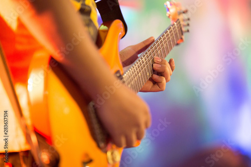 musicians are playing electric guitar on the stage