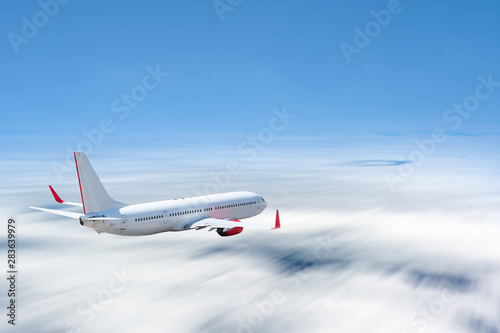 White airplane flying above cloud at daytime with motion blur effect