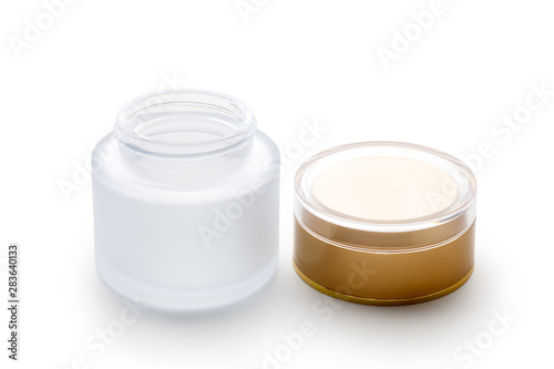 Empty cosmetic glass jar with golden lid. Isolated on white background. Skin care bottles for gel, lotion, cream.