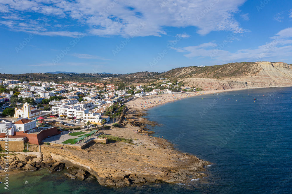 Fort and beautiful beach, Praia da Luz, Algarve, Portugal, summer aerial drone wide view