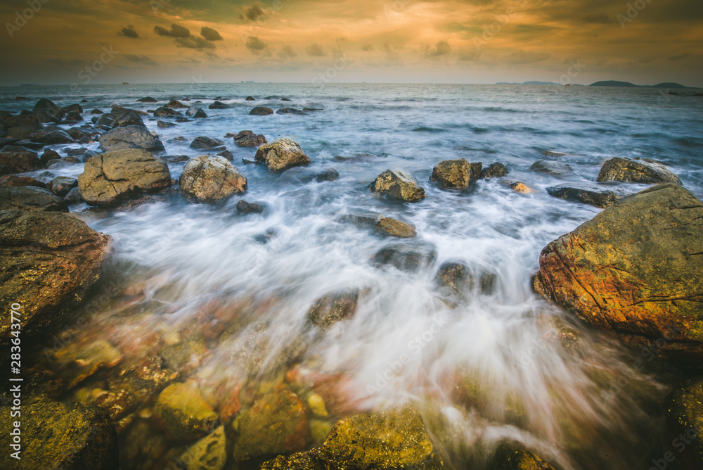 Sunset seascape with rocky beach and crashing waves, Rocks and stone in the sea with wave on sunset time, Nature landscape -Image