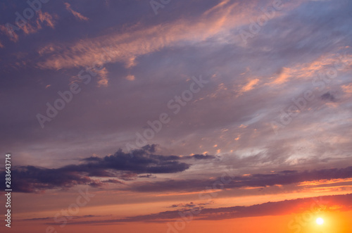 Dawn orange sun in dramatic clouds in the early morning. © Sviatoslav Khomiakov