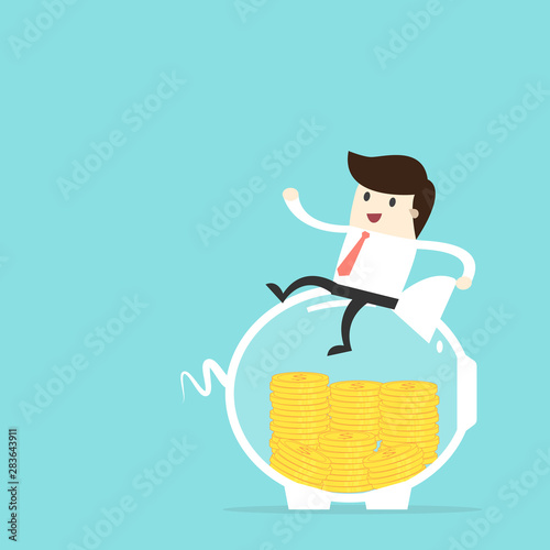 Businessman sit on piggy bank with a pile of coins,investment concept
