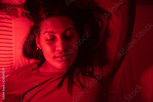 Portrait of woman shot from directly above in dark room 