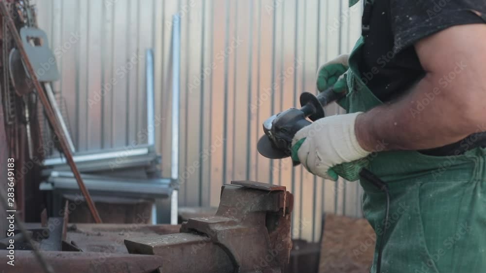 a man as a hobby marks and cuts metal for the household in his workshop. Applies an electric tool. a man as a hobby marks and cuts metal for the household in his workshop. Applies an electric tool.